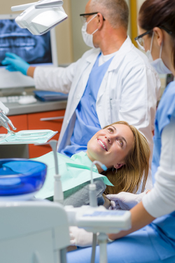 woman smiling during dental procedure
